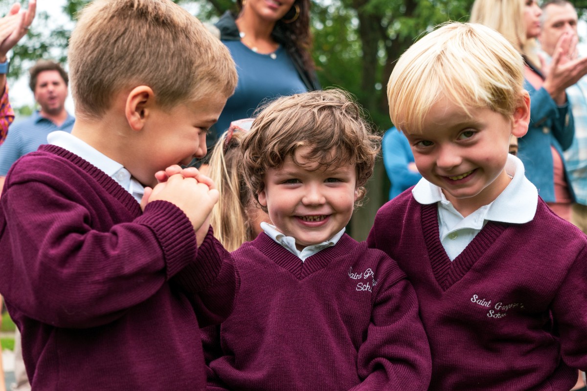 Three private school students smiling in Albany, NY on their first day of school