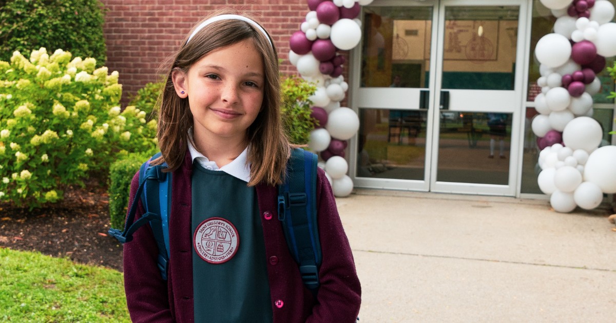 private school 4th grader in front of Saint Gregory's School at the first day of school