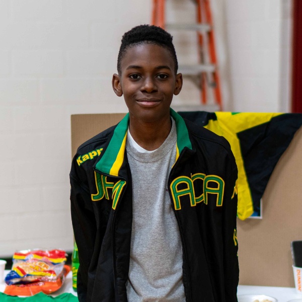 Private school student Calvin set up a table representing Jamaica at the SGS Multi-Cultural Fair