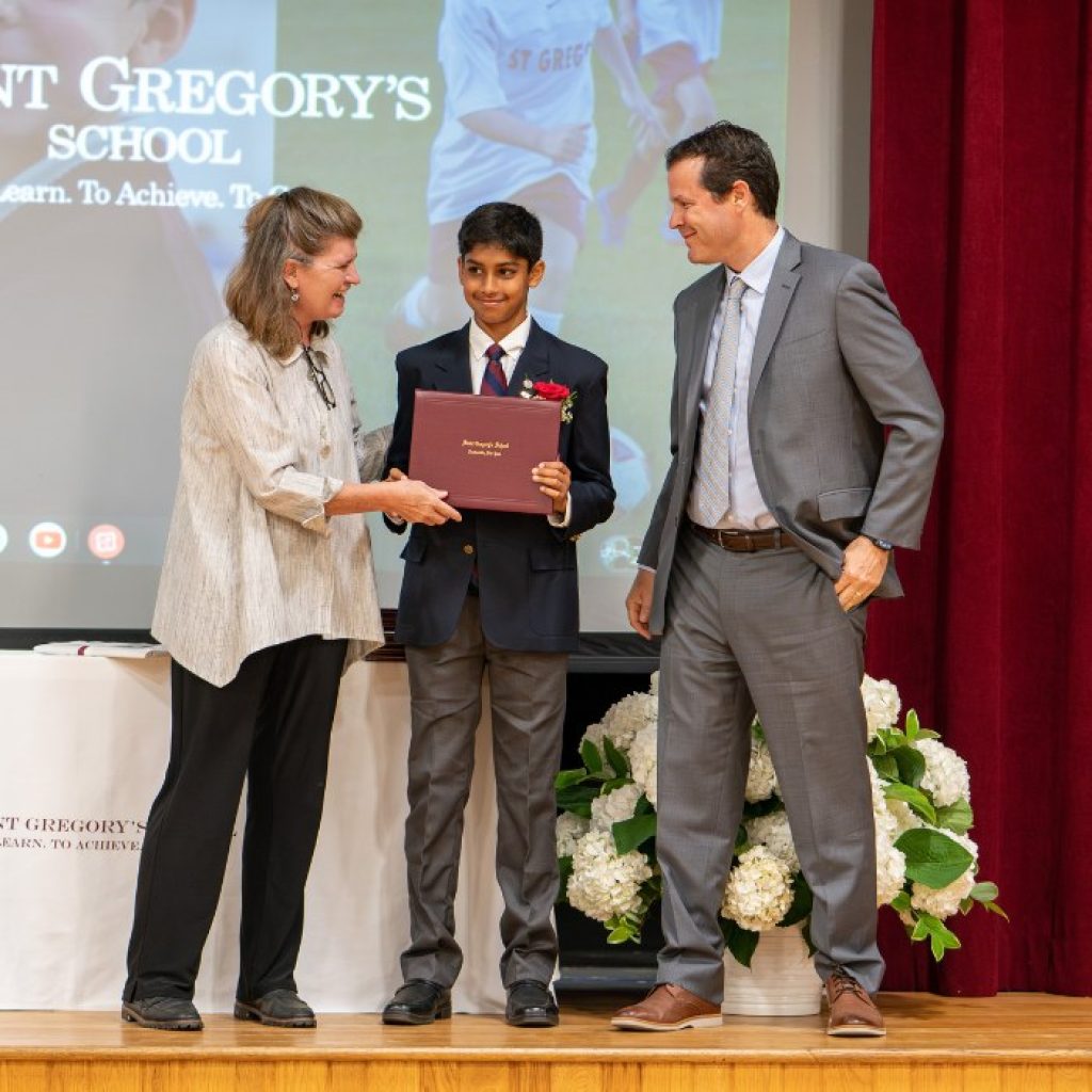 private school 8th grader receiving his diploma at graduation in Albany, NY