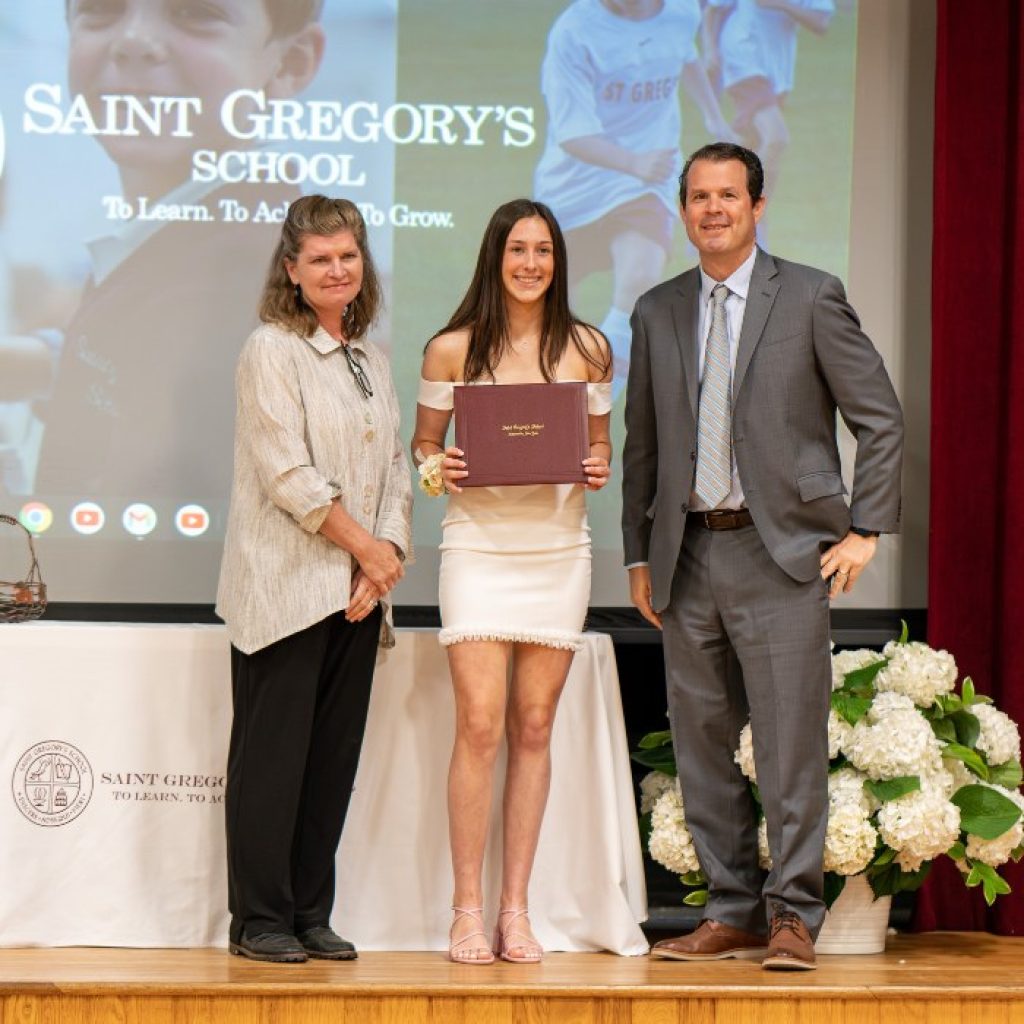 private school student receiving her diploma at graduation