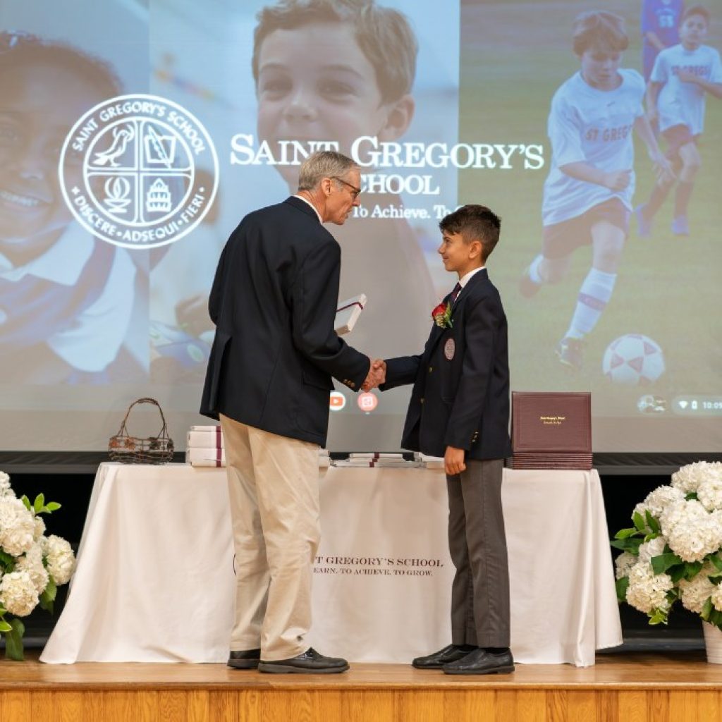 private school 8th grader receiving the Excellence in Latin award at his graduation