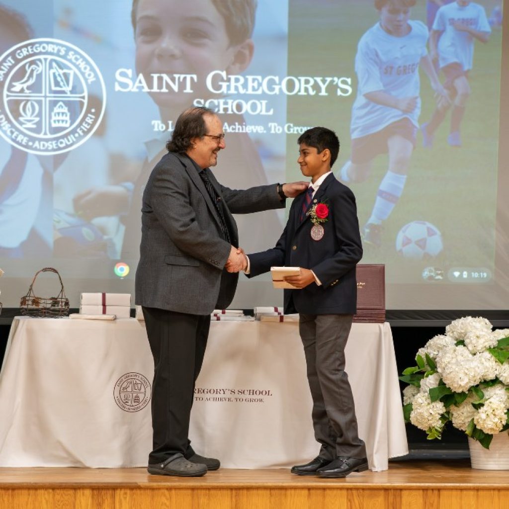 private school 8th grader receiving the Excellence in Religion award at his graduation