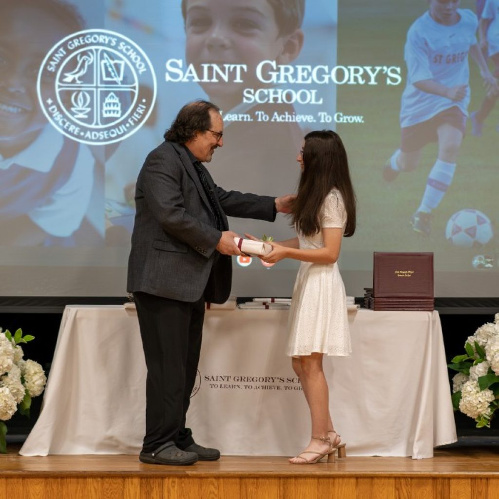 private school 8th grader receiving the Senior Research Paper award at her graduation