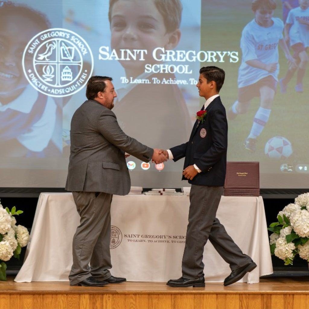 private school 8th grader receiving the Excellence in Tech award at his graduation