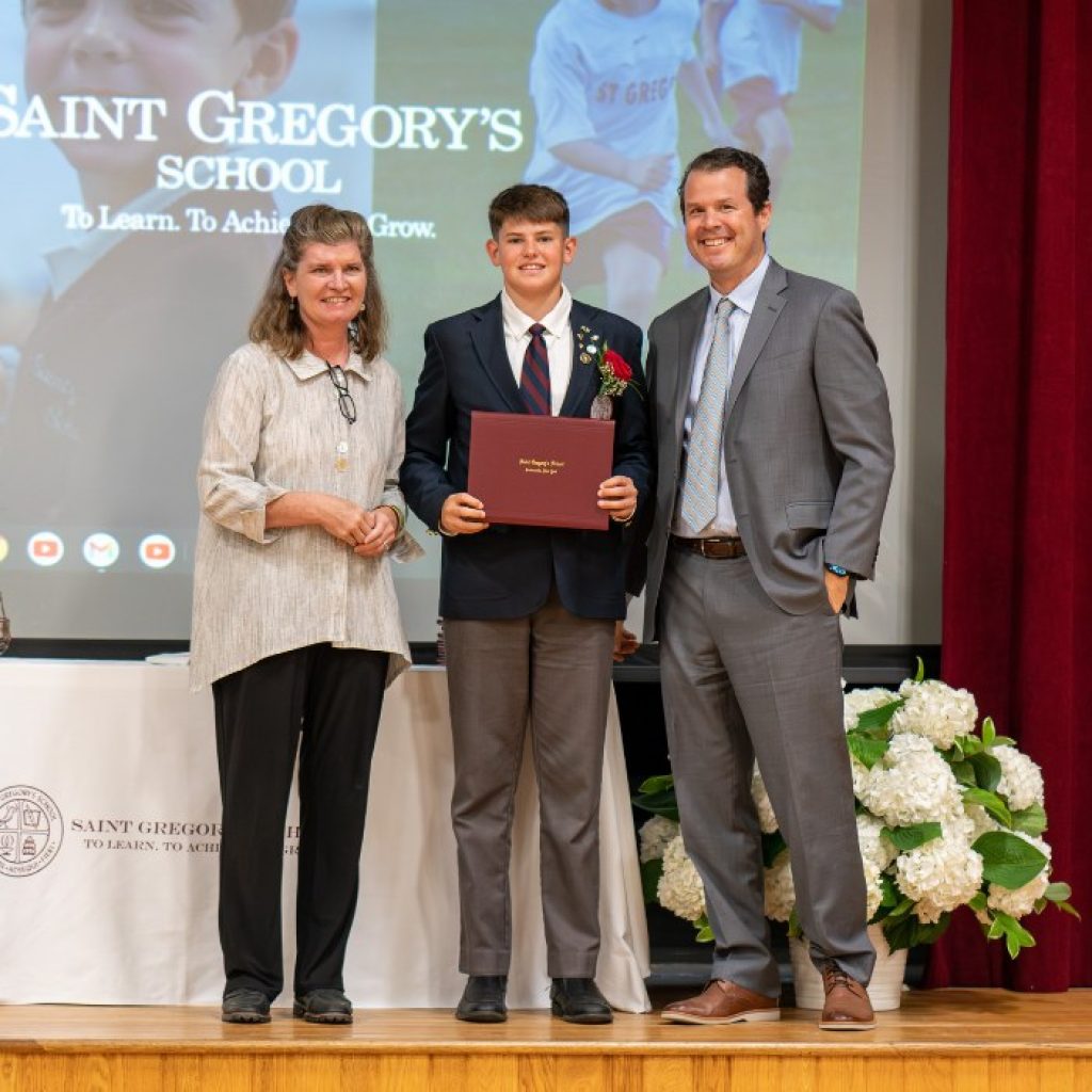 private school 8th grader receiving his diploma at graduation