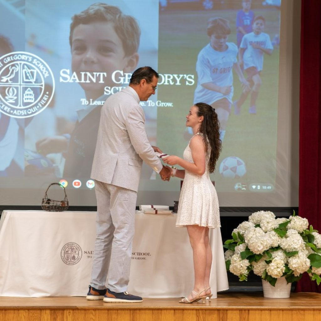 private school 8th grader receiving the Excellence in Athletics award at her graduation