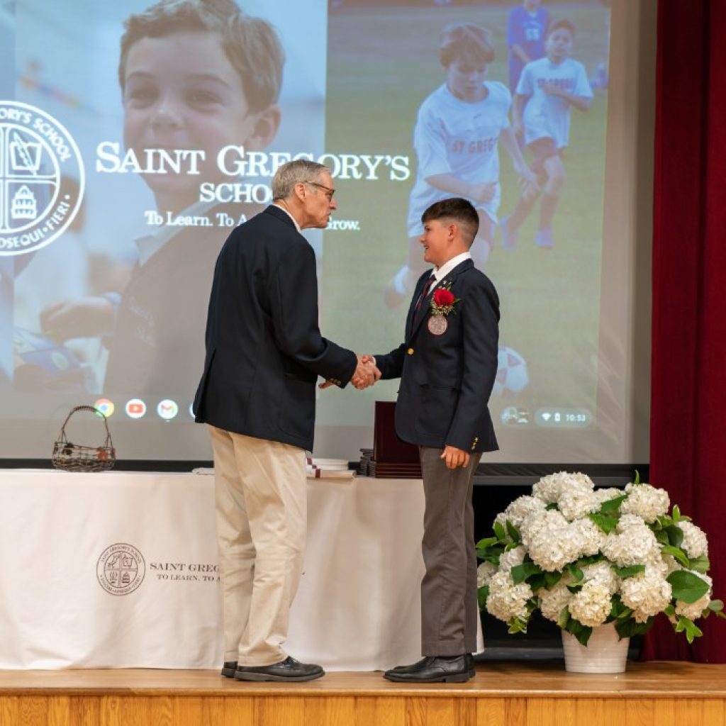 private school 8th grader receiving the Most Improved award at his graduation