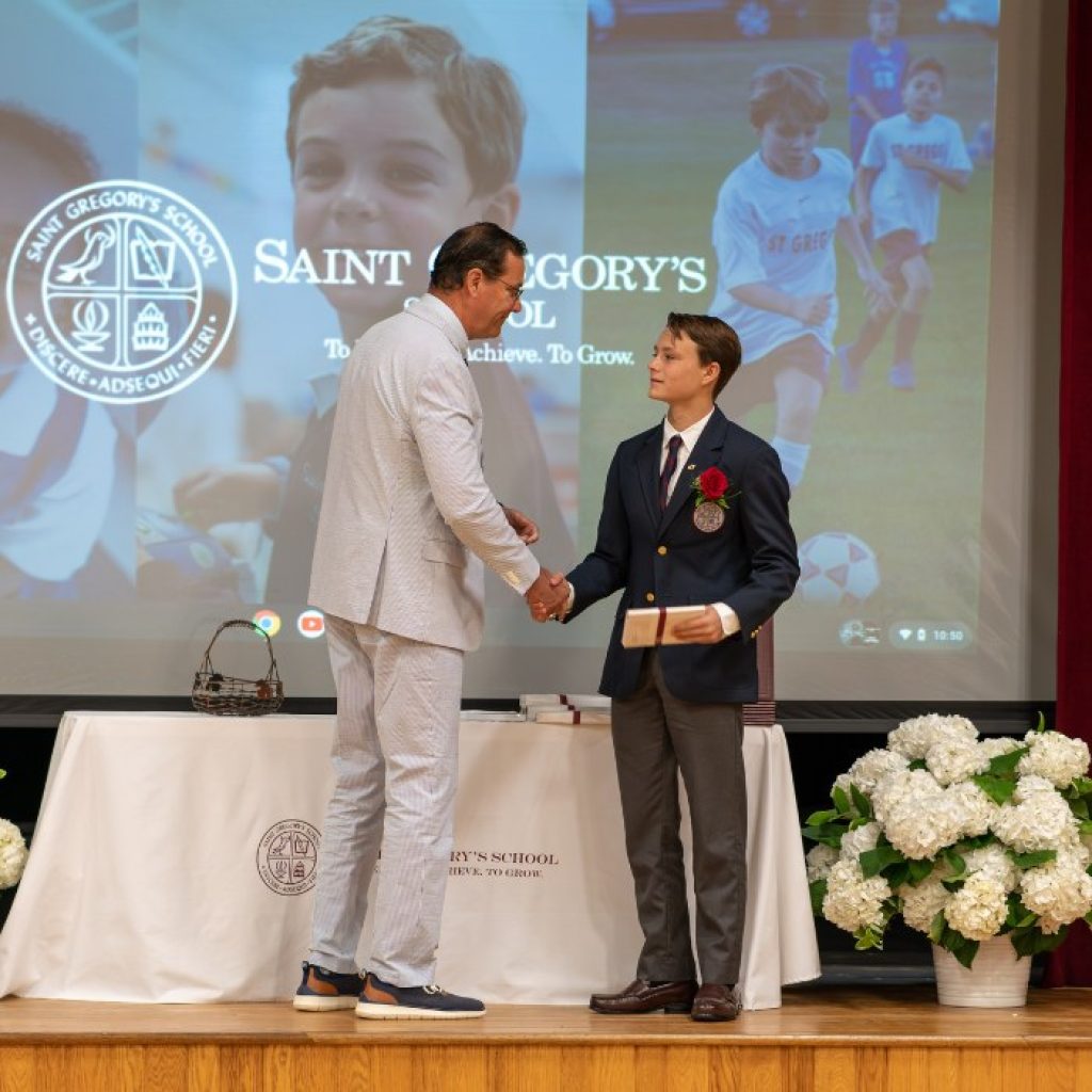 private school 8th grader receiving the Excellence in Athletics award at his graduation