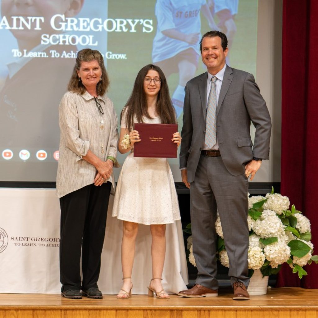 Saint Gregory's School student receiving her diploma at 8th grade graduation