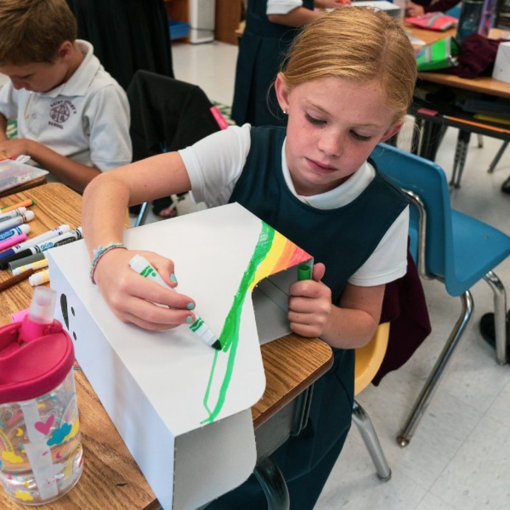 Saint Gregory's School student decorating her school supplies