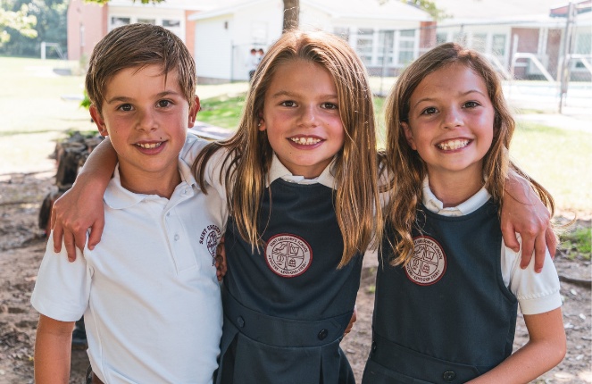 private school students smiling at Saint Gregory's School on their first day of school