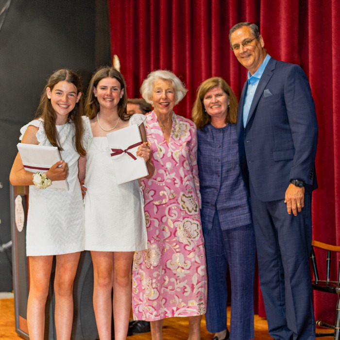 SGS private school students Grace and Julia receiving the Anne Smith Maloy Award for Excellence in Religious Studies Award