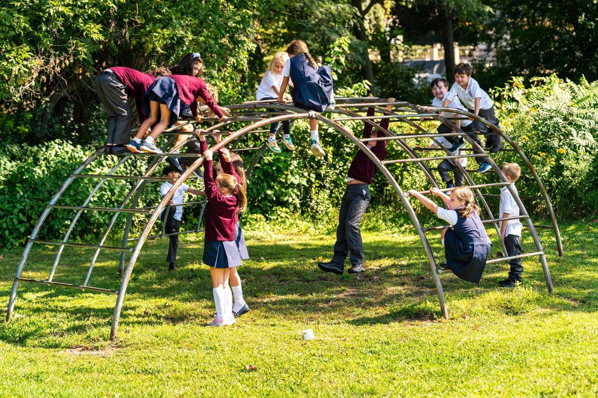 private school students enjoying recess at the monkey bars in Albany, NY