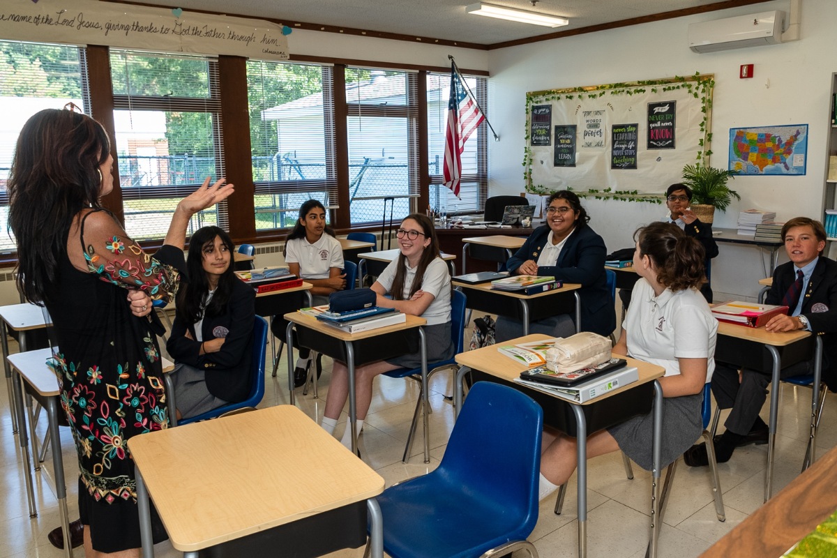 English teacher explaining something to private school students in Albany, NY