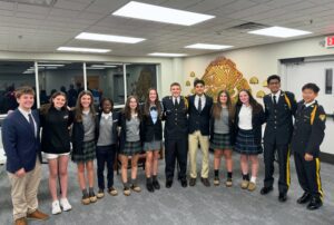 Current and Former Saint Gregory's School students smiling together into the camera during the SGS High School Fair