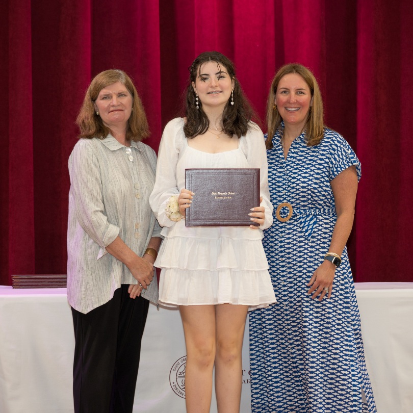 private school 8th grader Meave receiving an award on stage of Saint Gregory's School in Loudonville, NY
