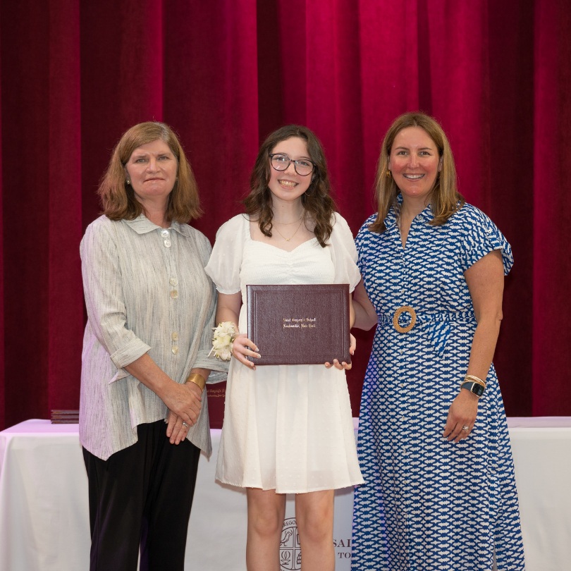 private school 8th grader Mady receiving an award on stage of Saint Gregory's School in Loudonville, NY